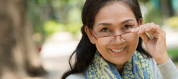 Woman looking at the camera over her glasses