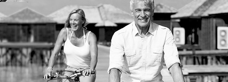 Mature couple riding bikes