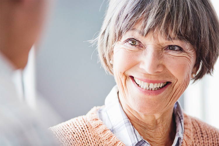 Older woman getting great news from her audiologist