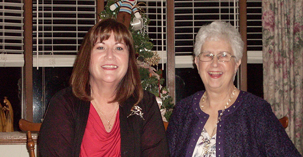 Kathy and Themla, sweepstakes winners, sitting on a couch and smiling