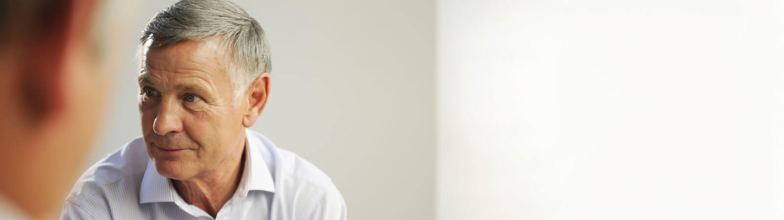 middle-age man talking to an audiologist