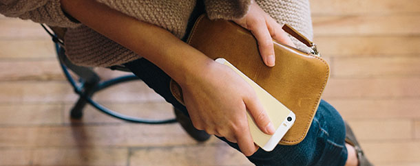 woman holding a smartphone in her lap