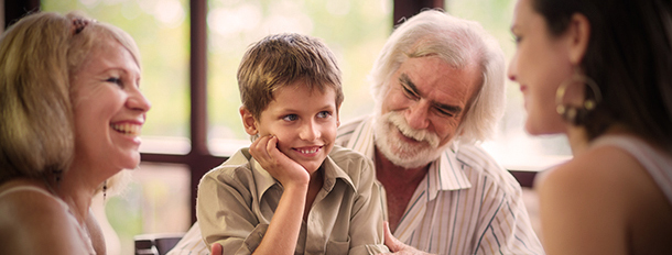 Boy sitting on his grandpa